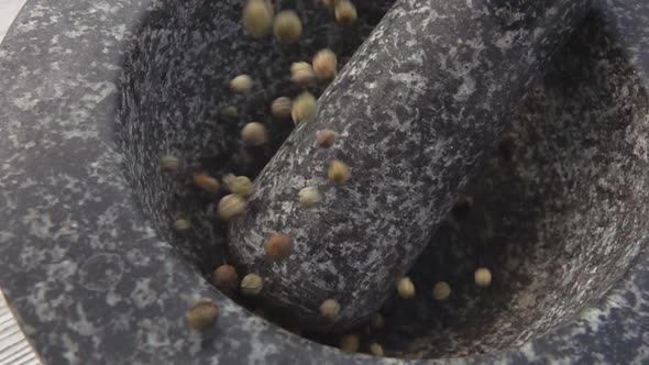 Spicy Black Peppercorns are Falling and Bouncing in the Grey Stone Mortar