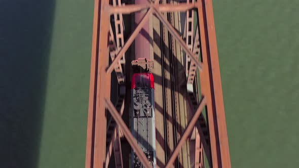 Freight Train Crossing an Iron Bridge Spanning a River