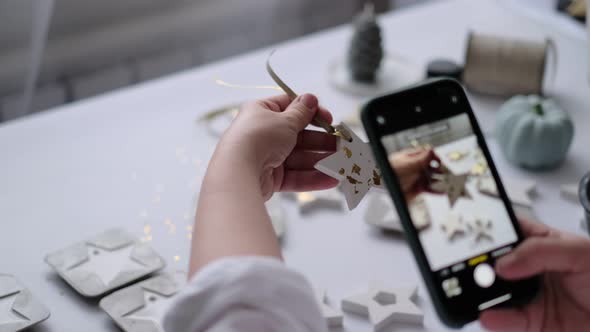 Woman Photographs a Finished Handicraft for Her Social Networks