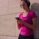 Young Woman is Listening to Music By Wireless Headphones Switching Songs in Smartphone - VideoHive Item for Sale