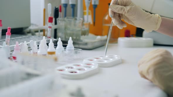 One Laboratory Worker Tests Samples on a Pallete