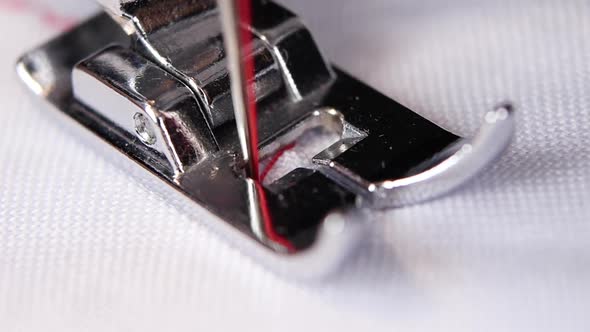 Sewing Machine Performs Original Stitch Thin Red Thread. Slow Motion