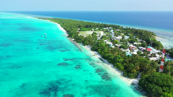 Aerial flying over tourism of idyllic island beach wildlife by aqua blue sea with white sandy backgr
