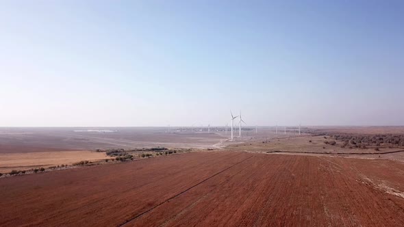 Windmills near the field. Top view from a drone.