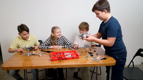 Happy Kids Helping Boy Create Toy