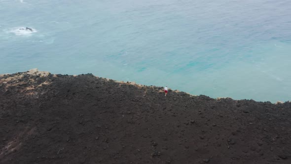 Man Standing on Cliff of Capelinhos Volcano Faial Island Azores Portugal