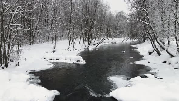 New Year's Snowy Beautiful Landscape with a Nonfreezing River Aerial View