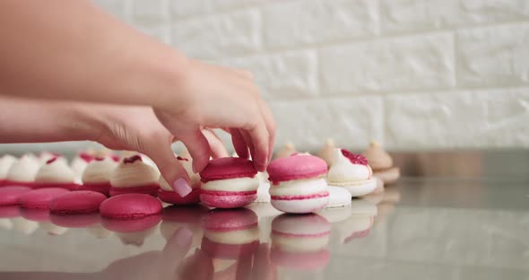 Connecting The Two Halves Shells Of Macarons Decorated With Jam And Ganache