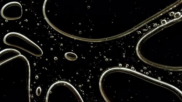 Transparent Cosmetic Gel Fluid with Molecule Bubbles Oil on Black Background