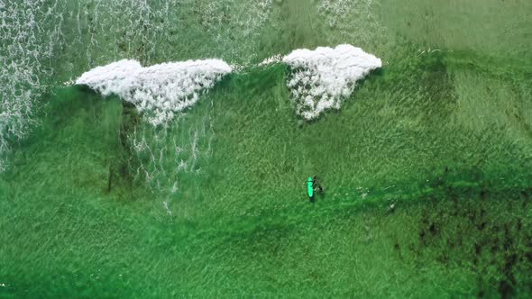 Two Surfers in the Sea, Top View. Norway Lofoten Islands