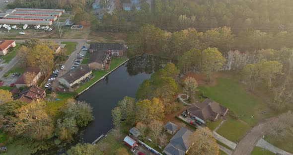 Aerial View of American House Apartment Complex on Area Urban Development Near Small Pond in Denham