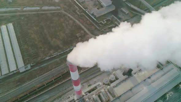 Aerial Drone View of Tall Chimney Pipes with Grey Smoke From Coal Power Plant