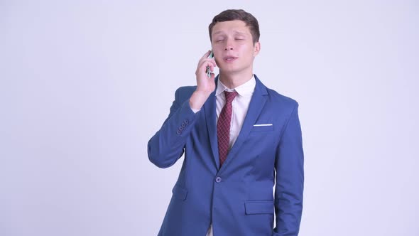 Happy Young Handsome Businessman Talking on the Phone