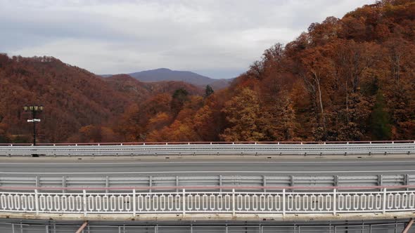 Aerial View of the Highway Viaduct on Concrete Pillars in the Mountains. Flight Over Autobahn