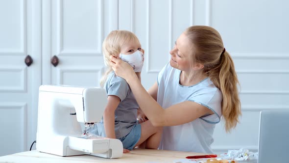 Concept, Family During Quarantine Self-isolation, Mom Puts Her Son in a Mask for Protection