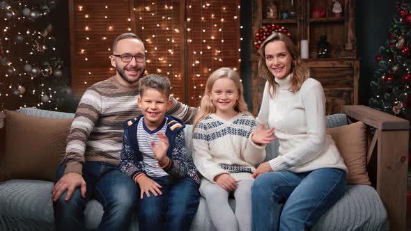 Smiling Family Posing at Cosiness Decorated Christmas Eve Home