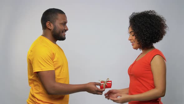 Happy African American Couple with Red Gift Box