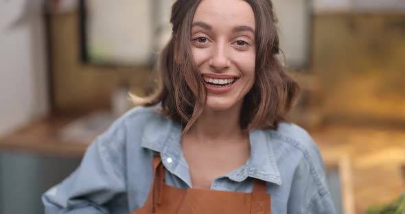 Portrait of a Happy Housewife on the Kitchen