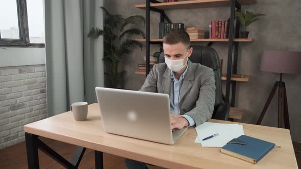 Man in Face Mask Office Workplace. Remote Chatting Colleague Internet Online Meeting Conference