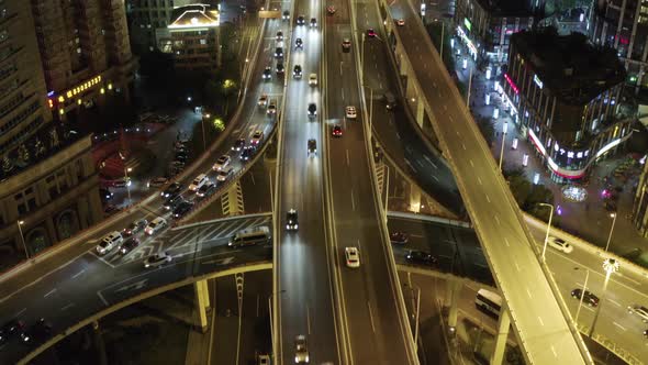 Aerial view of vehicles driving a road in Shanghai at night, China. alt