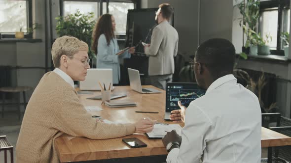 Multi-Ethnic Coworkers Examining Business Documents