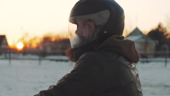 Man Rides a Motorcycle in Cold Winter