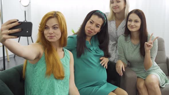 Four Young Pretty Caucasian Girls Making Group Selfie