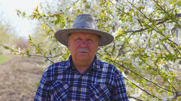 Old Man Charismatic Farmer with Hat Looking at Camera
