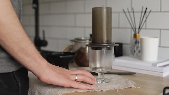 Barista Makes Aeropress Step By Step. Pours water.Alternative Coffee