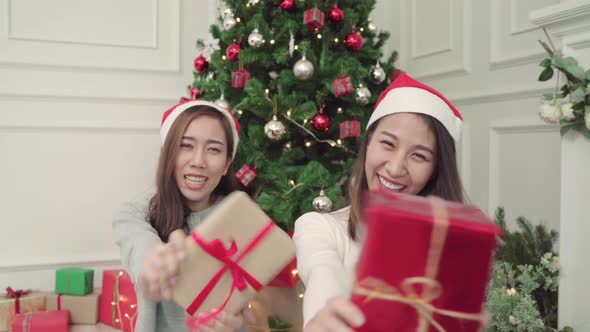 Group young Asian women giving christmas gifts to each other in Christmas Festival.