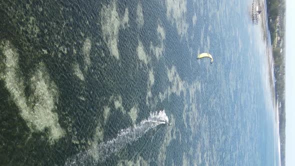 Vertical Video Kitesurfing Near the Shore of Zanzibar Tanzania Aerial View