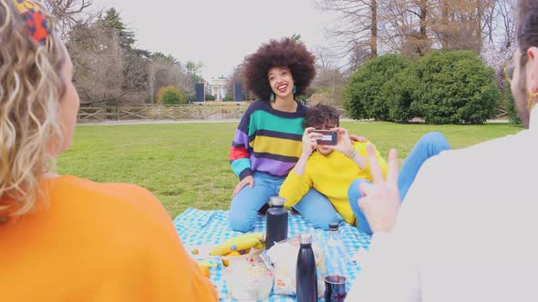 Four multiethnic friends outdoor using smartphone