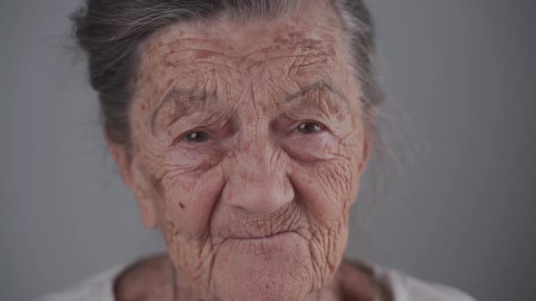 Portrait of Caucasian Toothless Senior Woman 90 Years Old with Deep Wrinkles and Gray Hair Cute