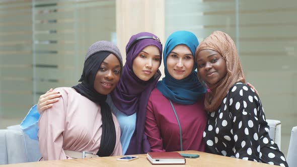 Portrait of Multiracial Group of Muslim Women Dressed in National Dresses Posing in Shopping Centre.