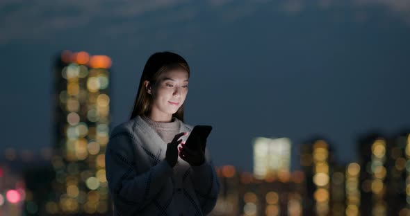 Woman use of smart phone at night