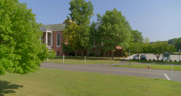 POV Flying Past Tree and Towards a Colonial Revival Architecture Style Building