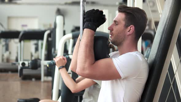 Athletic Gym Trainer Doing Chest Press Exercise.