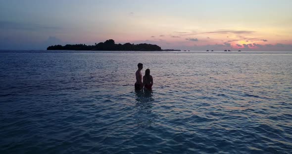 Fun people on romantic honeymoon enjoy luxury on beach on white sand background 