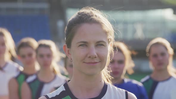 Female hockey players smiling and looking at camera