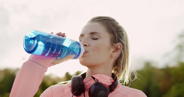 Handheld view of woman taking a sip of refreshing water 