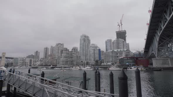 View of Yaletown apartments from Granville Island dock on cloudy day