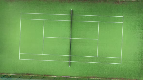 Drone circle zoom out top shot flying over tennis court Aerial top round shot of tennis court, tenni