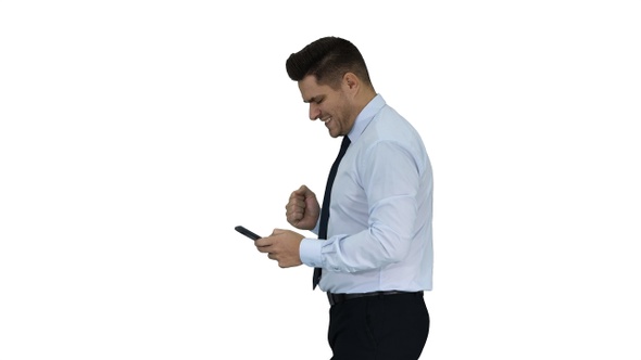 Man walking looking on phone and making win gesture on
