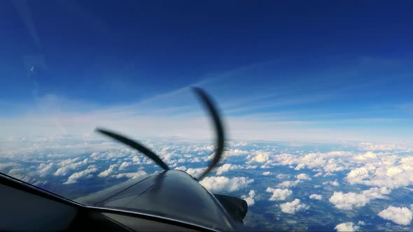 A Private Plane Flies Above the Clouds - a View From the Cockpit - Spinning Propeller