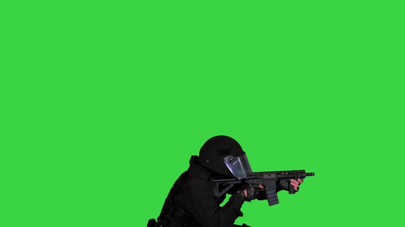 Special Forces Unit Shooting From Sitting Position on a Green Screen Chroma Key