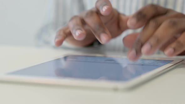Close Up of African Man Using Digital Tablet