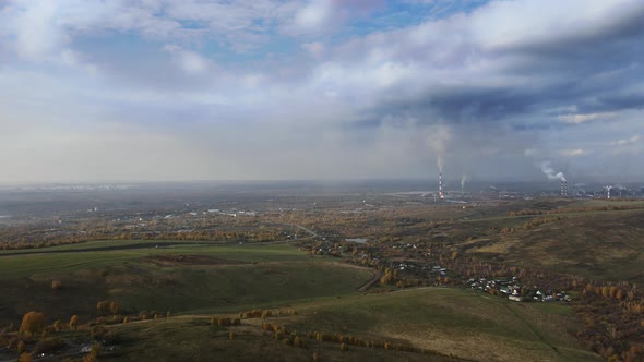 Aerial View of Factory in the City Surrounded By Beautiful Nature. Pipes with Chemical Smoke of