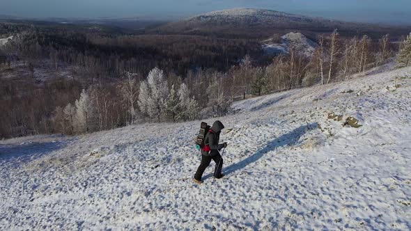 A Lonely Traveler Walks Along the Top of a Mountain Range