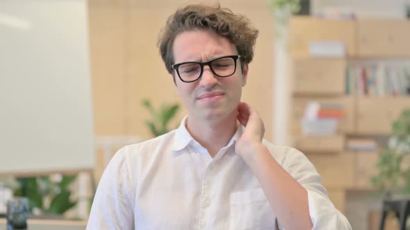 Portrait of Young Man Having Neck Pain