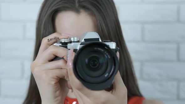 The camera in the hands of a girl close-up.